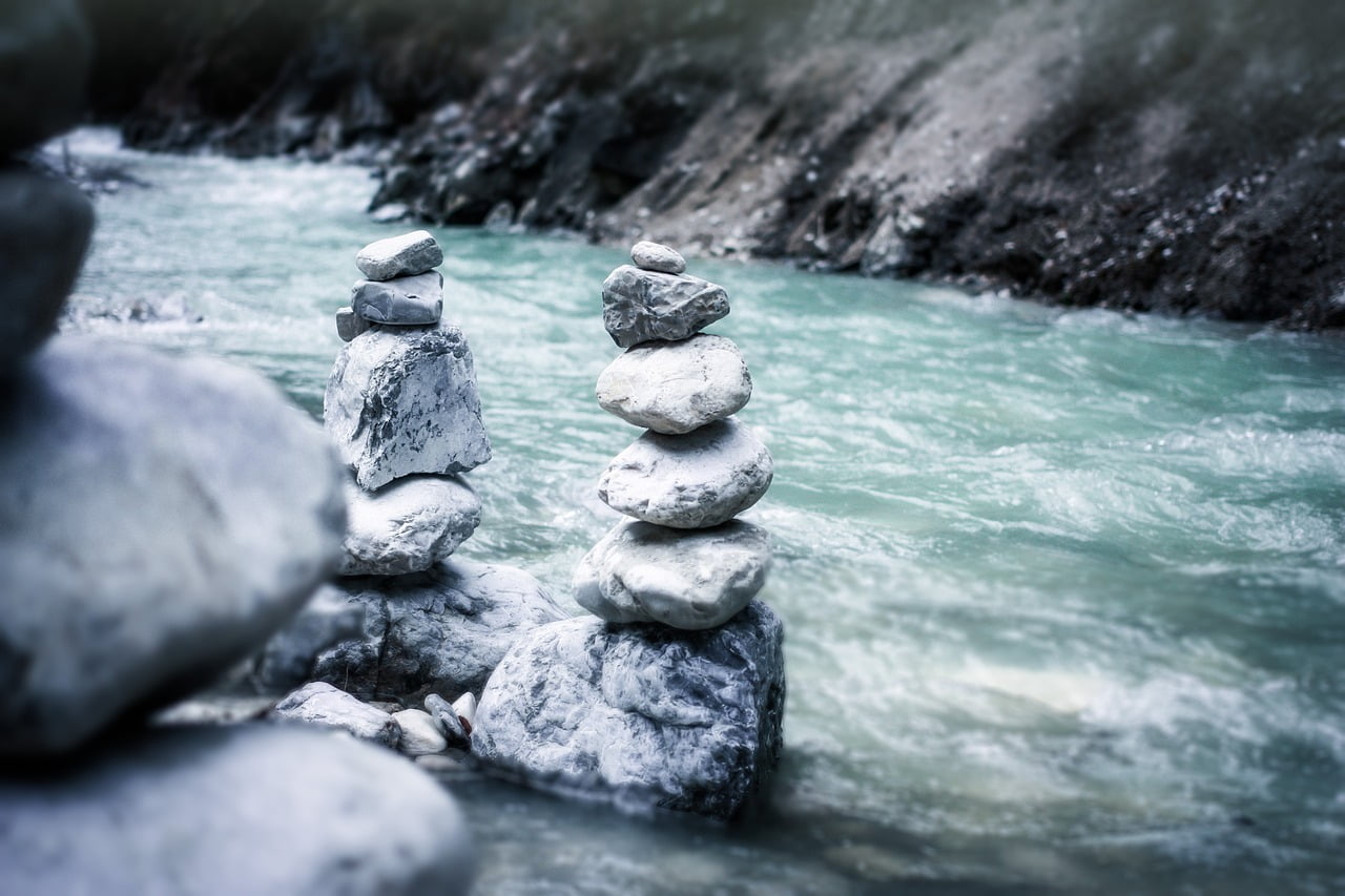 Risk Parity Investing Strategies with Rock pile stacked in the river 