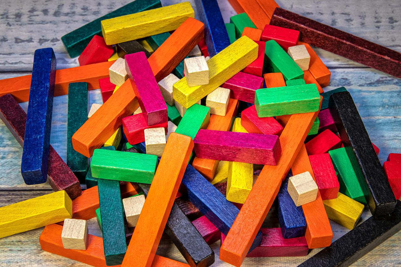 Merger Arbitrage and Long short wooden colorful sticks piled on each other