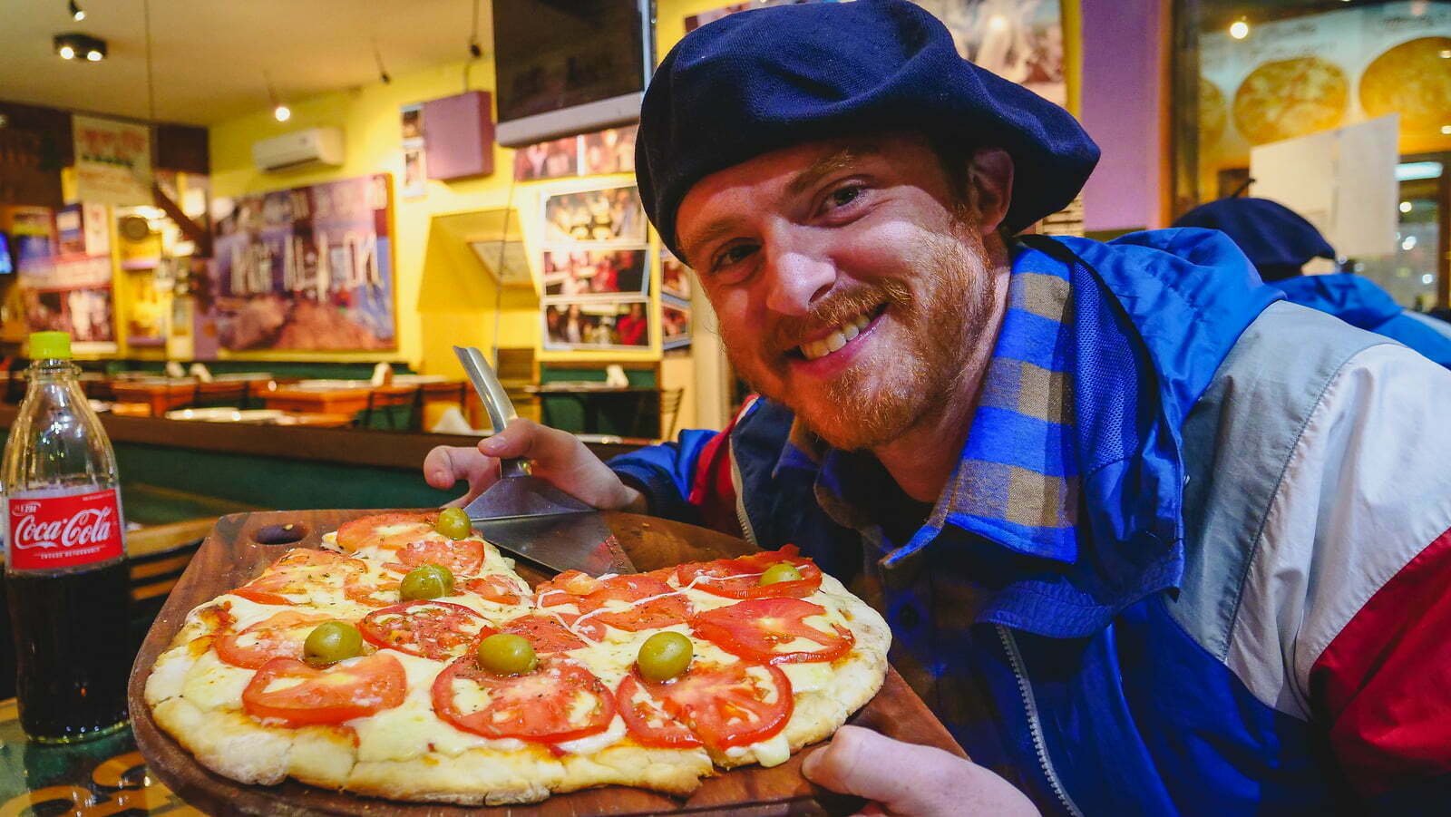 Nomadic Samuel eating pizza in Argentina