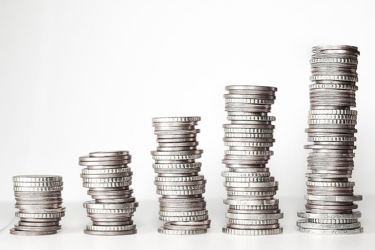 Coins stacked in piles next to each other 