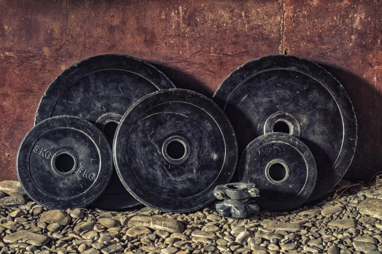 Barbells stacked together against the wall 