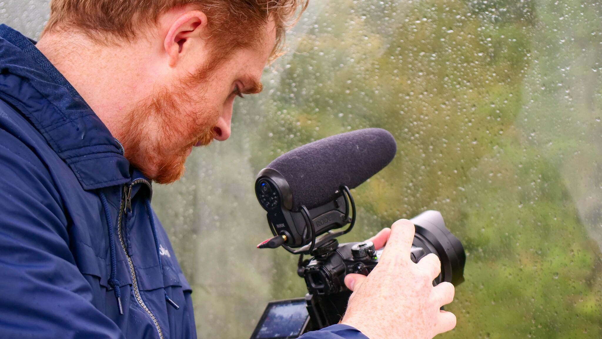 Nomadic Samuel recording travel videos in Germany on a rainy day