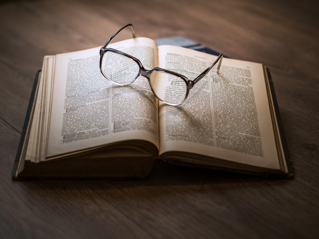 Books with glasses on top