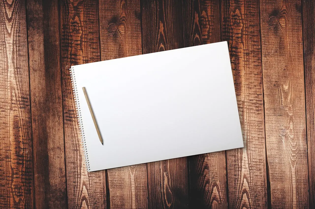 Pen and notebook on a simple wooden desk