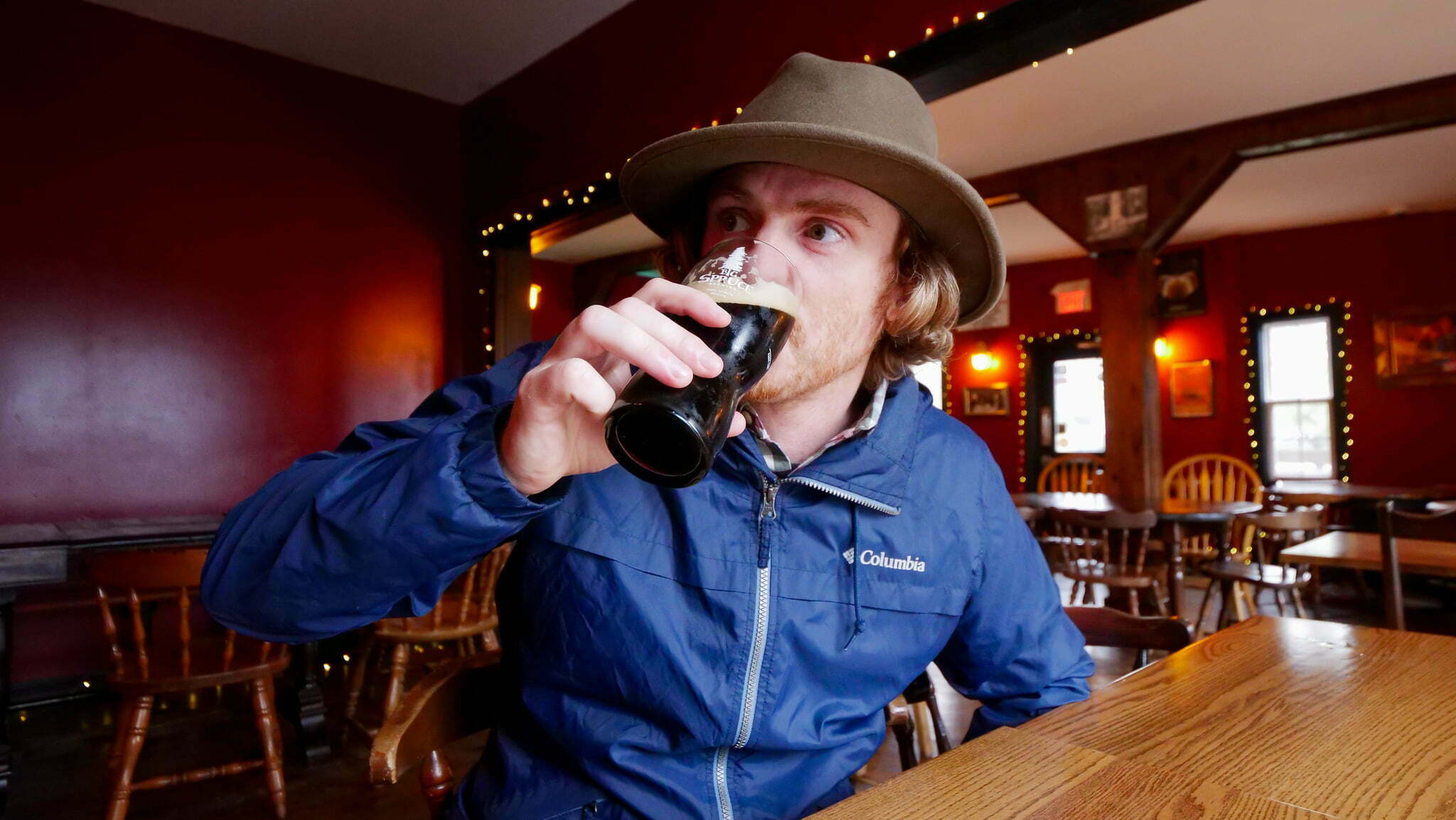 Nomadic Samuel drinking beer in Nova Scotia, Canada